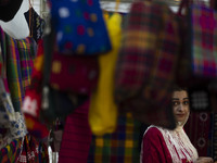 An Iranian saleswoman stands at her stand during the 11th National Handicrafts and 3rd International Tourism Exhibition in Tabriz, Iran, on...