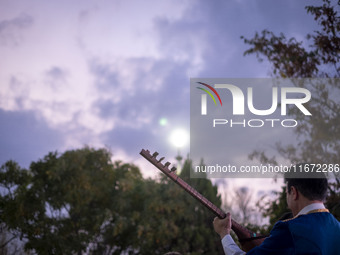 An Iranian musician plays a traditional musical instrument while participating in the 11th National Handicrafts and 3rd International Touris...