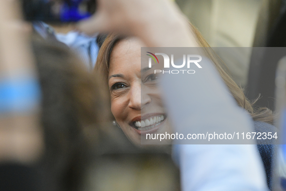 U.S. Vice President Kamala Harris greets supporters after a campaign event, standing with a group of current and former Republicans, at Wash...