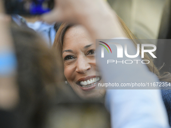 U.S. Vice President Kamala Harris greets supporters after a campaign event, standing with a group of current and former Republicans, at Wash...