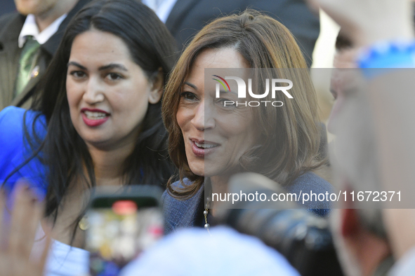 U.S. Vice President Kamala Harris greets supporters after a campaign event, standing with a group of current and former Republicans, at Wash...