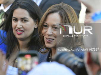 U.S. Vice President Kamala Harris greets supporters after a campaign event, standing with a group of current and former Republicans, at Wash...