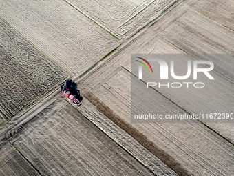 A man plows soil in a tractor on an agricultural field as the planting season of Galicia garlic continues on October 16, 2024. Galicia garli...