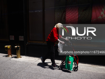  An woman walsk with a rollator in Manhattan, New York City, United States of America on July 6th, 2024. (