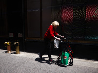  An woman walsk with a rollator in Manhattan, New York City, United States of America on July 6th, 2024. (