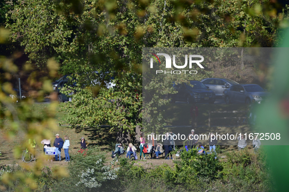 People watch from across the Delaware River as U.S. Vice President Kamala Harris holds a campaign event with a group of current and former R...