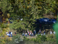 People watch from across the Delaware River as U.S. Vice President Kamala Harris holds a campaign event with a group of current and former R...