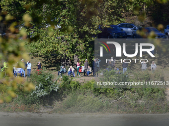 People watch from across the Delaware River as U.S. Vice President Kamala Harris holds a campaign event with a group of current and former R...