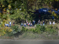 People watch from across the Delaware River as U.S. Vice President Kamala Harris holds a campaign event with a group of current and former R...