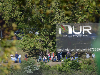 People watch from across the Delaware River as U.S. Vice President Kamala Harris holds a campaign event with a group of current and former R...