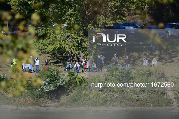 People watch from across the Delaware River as U.S. Vice President Kamala Harris holds a campaign event with a group of current and former R...