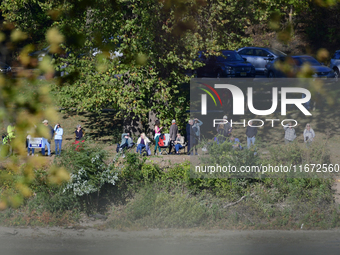 People watch from across the Delaware River as U.S. Vice President Kamala Harris holds a campaign event with a group of current and former R...