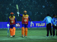 Yusuf Pathan raises his bat after scoring 50 runs during the finals of the Legends League Cricket T20 match between Southern Superstars and...