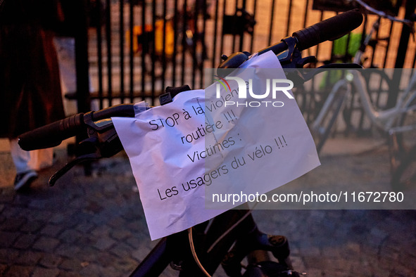 People gather to pay tribute to Paul, a 27-year-old cyclist who was run over by a car following a dispute in Paris one day earlier, at Place...