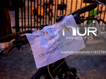 People gather to pay tribute to Paul, a 27-year-old cyclist who was run over by a car following a dispute in Paris one day earlier, at Place...