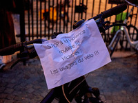 People gather to pay tribute to Paul, a 27-year-old cyclist who was run over by a car following a dispute in Paris one day earlier, at Place...