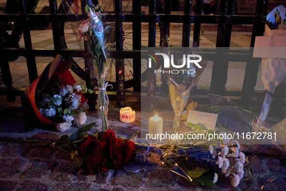 People gather to pay tribute to Paul, a 27-year-old cyclist who was run over by a car following a dispute in Paris one day earlier, at Place...