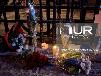 People gather to pay tribute to Paul, a 27-year-old cyclist who was run over by a car following a dispute in Paris one day earlier, at Place...