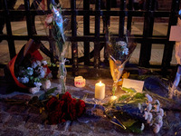 People gather to pay tribute to Paul, a 27-year-old cyclist who was run over by a car following a dispute in Paris one day earlier, at Place...