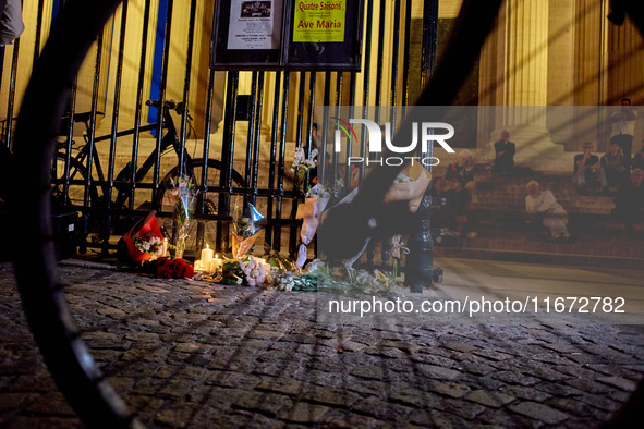 People gather to pay tribute to Paul, a 27-year-old cyclist who was run over by a car following a dispute in Paris one day earlier, at Place...