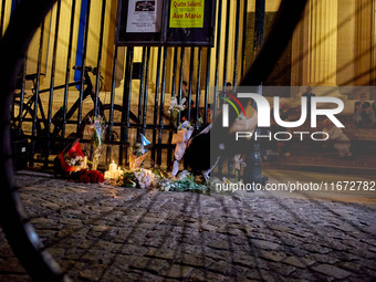 People gather to pay tribute to Paul, a 27-year-old cyclist who was run over by a car following a dispute in Paris one day earlier, at Place...