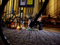 People gather to pay tribute to Paul, a 27-year-old cyclist who was run over by a car following a dispute in Paris one day earlier, at Place...