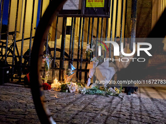 People gather to pay tribute to Paul, a 27-year-old cyclist who was run over by a car following a dispute in Paris one day earlier, at Place...