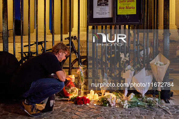 People gather to pay tribute to Paul, a 27-year-old cyclist who was run over by a car following a dispute in Paris one day earlier, at Place...