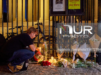 People gather to pay tribute to Paul, a 27-year-old cyclist who was run over by a car following a dispute in Paris one day earlier, at Place...