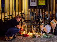 People gather to pay tribute to Paul, a 27-year-old cyclist who was run over by a car following a dispute in Paris one day earlier, at Place...