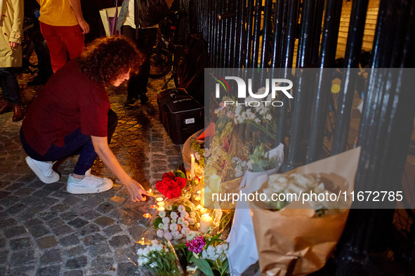 People gather to pay tribute to Paul, a 27-year-old cyclist who was run over by a car following a dispute in Paris one day earlier, at Place...