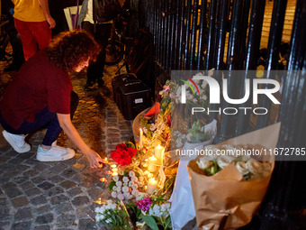 People gather to pay tribute to Paul, a 27-year-old cyclist who was run over by a car following a dispute in Paris one day earlier, at Place...