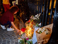 People gather to pay tribute to Paul, a 27-year-old cyclist who was run over by a car following a dispute in Paris one day earlier, at Place...