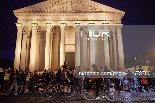 People gather to pay tribute to Paul, a 27-year-old cyclist who was run over by a car following a dispute in Paris one day earlier, at Place...