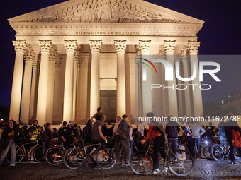 People gather to pay tribute to Paul, a 27-year-old cyclist who was run over by a car following a dispute in Paris one day earlier, at Place...