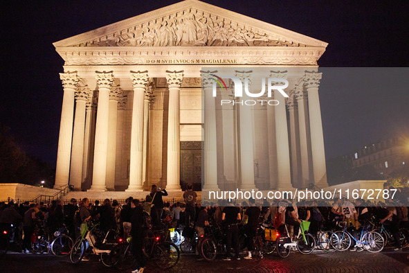 People gather to pay tribute to Paul, a 27-year-old cyclist who was run over by a car following a dispute in Paris one day earlier, at Place...