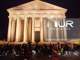 People gather to pay tribute to Paul, a 27-year-old cyclist who was run over by a car following a dispute in Paris one day earlier, at Place...