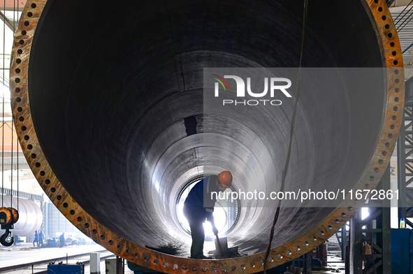 A worker works on the production line of a wind power equipment manufacturing enterprise in Baishui County, Weinan, China, on October 16, 20...