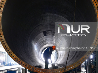 A worker works on the production line of a wind power equipment manufacturing enterprise in Baishui County, Weinan, China, on October 16, 20...