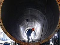 A worker works on the production line of a wind power equipment manufacturing enterprise in Baishui County, Weinan, China, on October 16, 20...