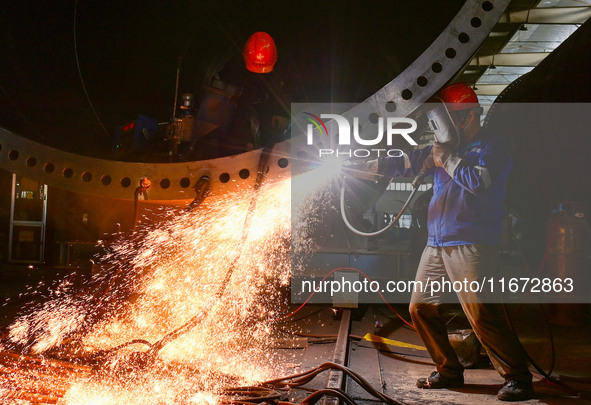 A worker works on the production line of a wind power equipment manufacturing enterprise in Baishui County, Weinan, China, on October 16, 20...