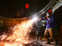 A worker works on the production line of a wind power equipment manufacturing enterprise in Baishui County, Weinan, China, on October 16, 20...