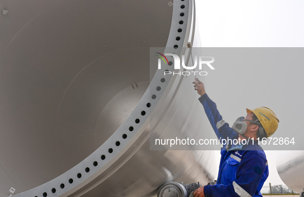 A worker works on the production line of a wind power equipment manufacturing enterprise in Baishui County, Weinan, China, on October 16, 20...