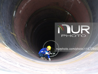 A worker works on the production line of a wind power equipment manufacturing enterprise in Baishui County, Weinan, China, on October 16, 20...