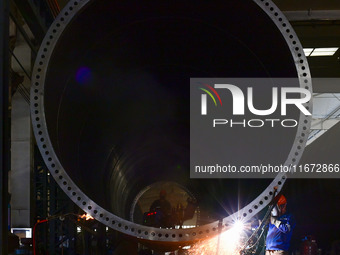 A worker works on the production line of a wind power equipment manufacturing enterprise in Baishui County, Weinan, China, on October 16, 20...