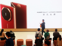 A customer experiences the Mate XT, a triple foldable screen phone, at Huawei's global flagship store in Shanghai, China, on October 15, 202...