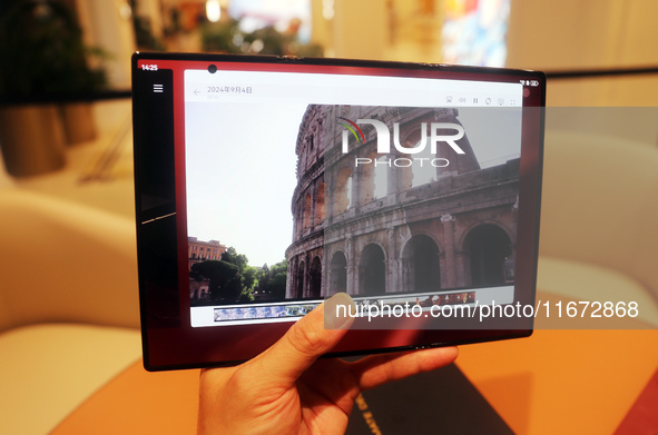 A customer experiences the Mate XT, a triple foldable screen phone, at Huawei's global flagship store in Shanghai, China, on October 15, 202...