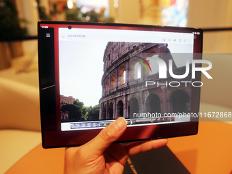 A customer experiences the Mate XT, a triple foldable screen phone, at Huawei's global flagship store in Shanghai, China, on October 15, 202...