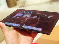 A customer experiences the Mate XT, a triple foldable screen phone, at Huawei's global flagship store in Shanghai, China, on October 15, 202...