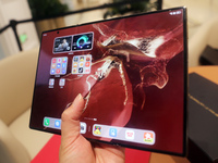 A customer experiences the Mate XT, a triple foldable screen phone, at Huawei's global flagship store in Shanghai, China, on October 15, 202...